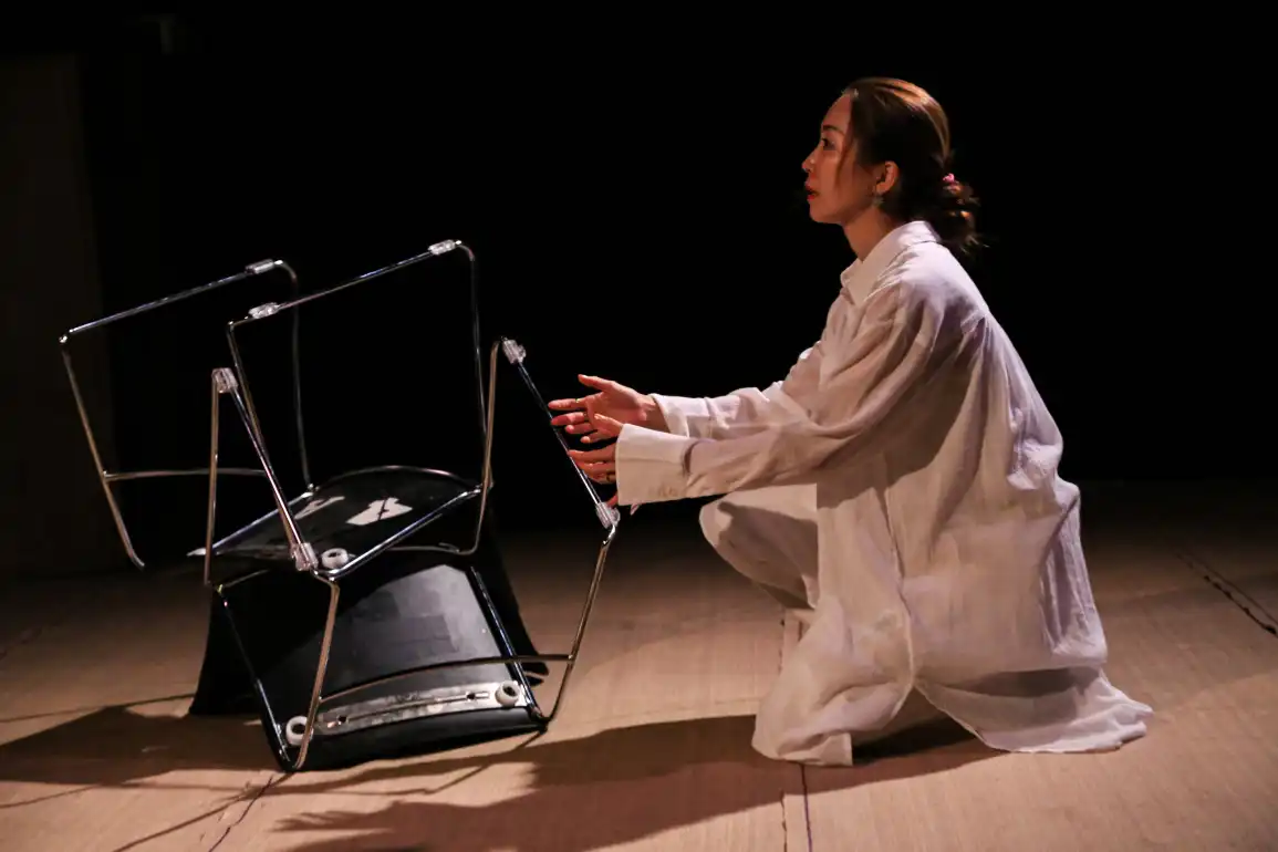 Character crouches next to flipped chair