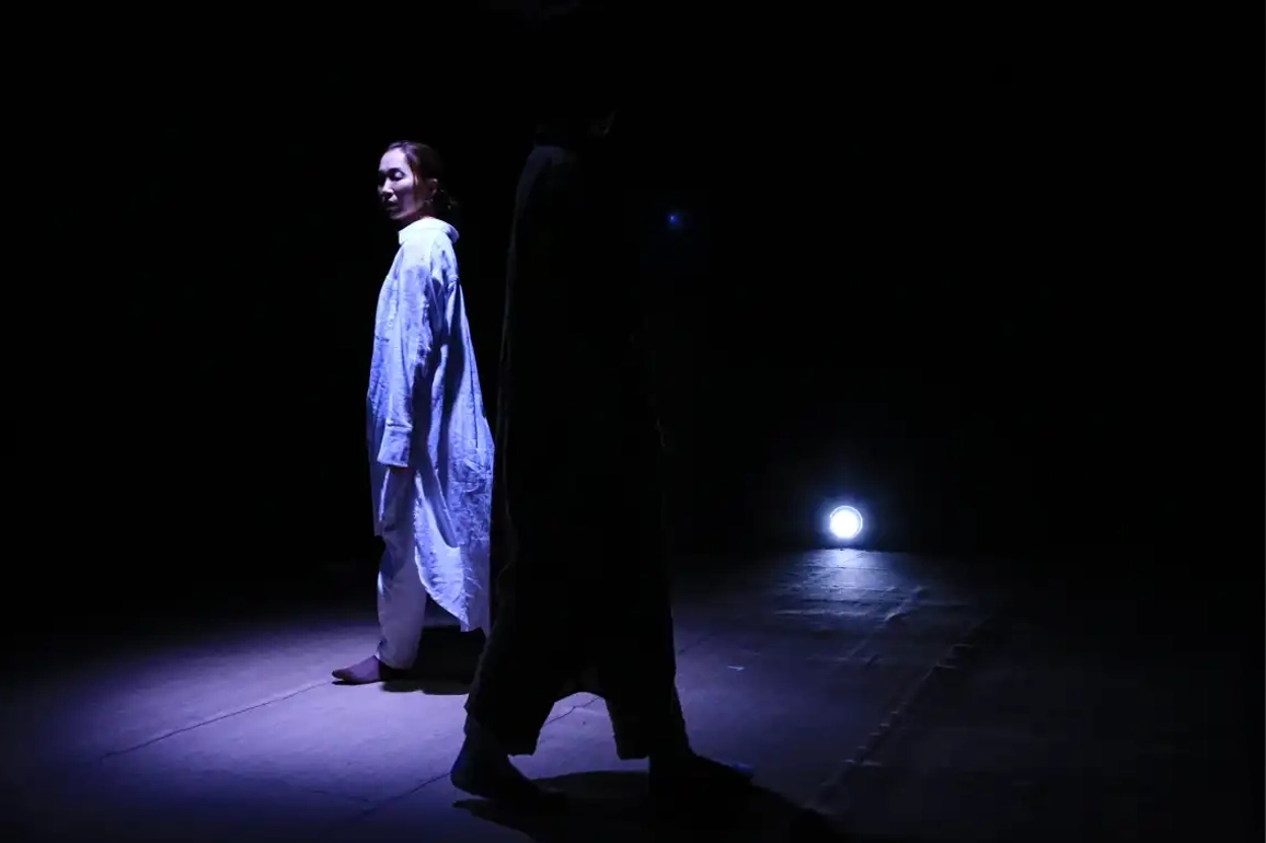 Character under spotlight, surrounded by other character