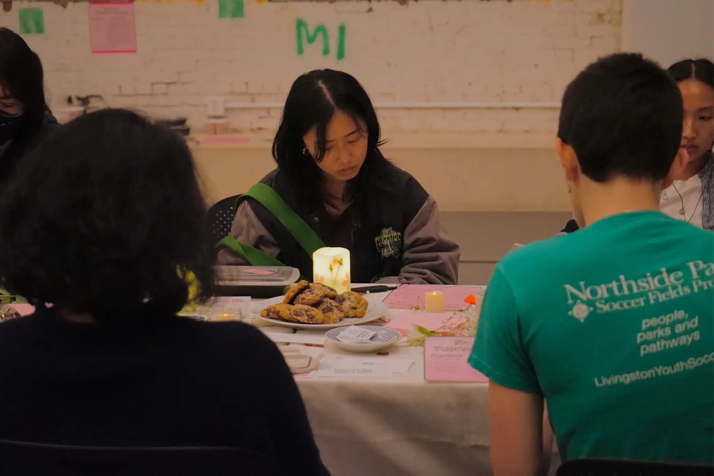 Various attendees wearing headphones, listening to recordings around the dining table